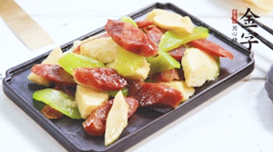 熱油下鍋，依次下金字香腸、萵筍、冬筍，均勻翻炒。