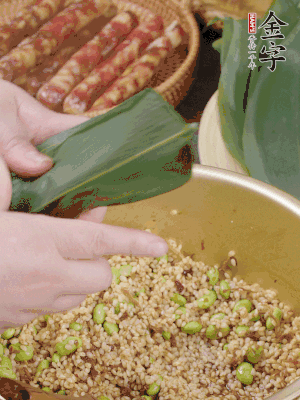 粽葉往下折，完全蓋住，兩側(cè)捏緊。