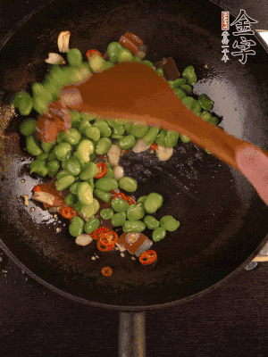 再下蠶豆煸炒，加1勺料酒調(diào)味。
